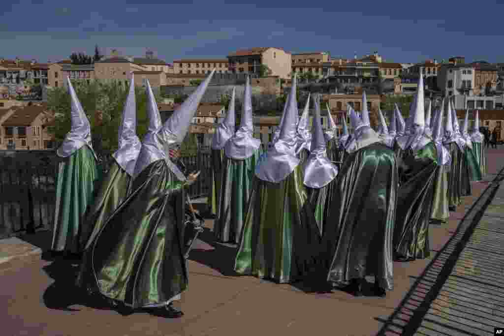 Penitents from 'Virgen de la Esperanza' brotherhood attend a procession in Zamora, Spain.