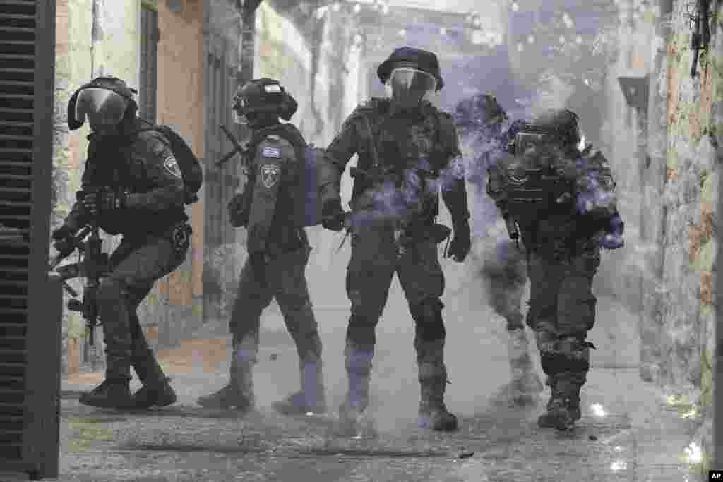 Palestinians shoot fireworks at Israeli police in the Old City of Jerusalem. Israeli police clashed with Palestinians outside Al-Aqsa Mosque after police cleared Palestinians from the sprawling compound to facilitate the routine visit of Jews to the holy site and accused Palestinians of stockpiling stones in anticipation of violence. 
