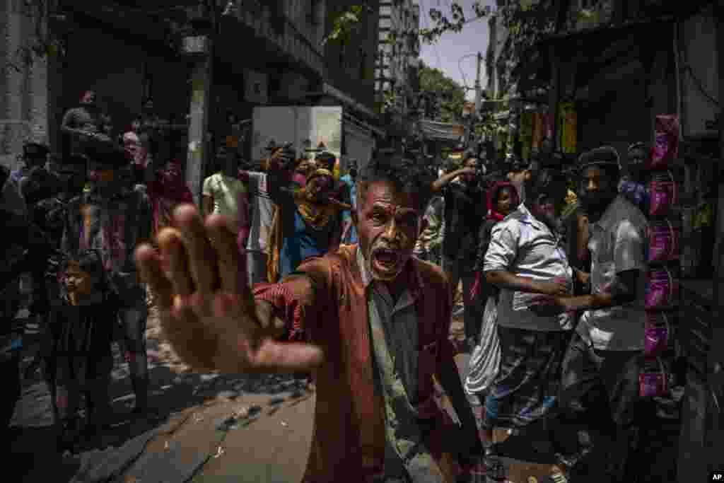 An agitated Muslim resident asks media to leave alleging them of distorting facts, during the demolition of Muslim-owned shops at the site of Saturday's communal violence, in New Delhi's northwest Jahangirpuri neighborhood, in New Delhi, India.