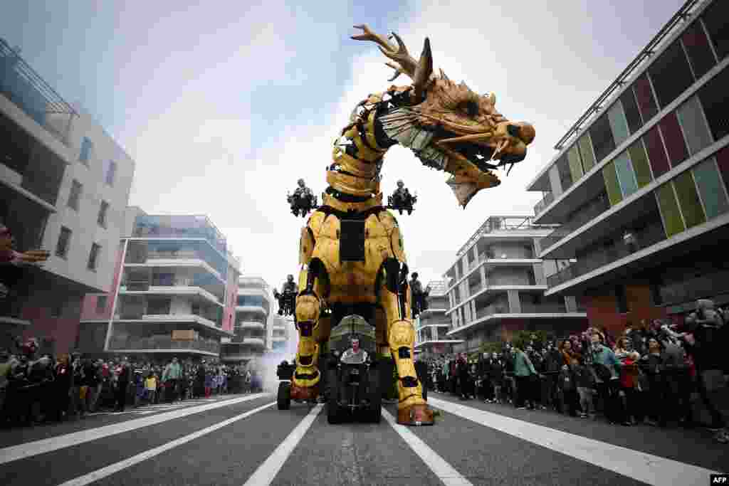Operators drive the dragon-horse called Long-Ma, created by Francois de la Roziere and his company "La Machine", in the streets of Toulouse, southern France, April 16, 2022.