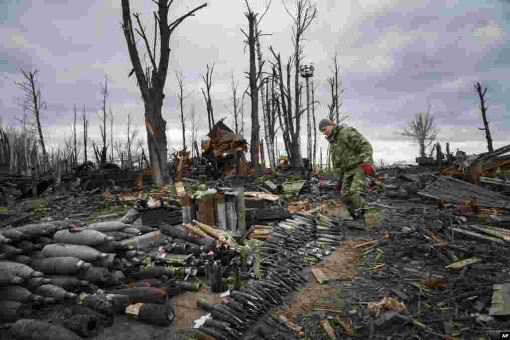 An interior ministry sapper collects unexploded shells, grenades and other devices in Hostomel, close to Kyiv, Ukraine.
