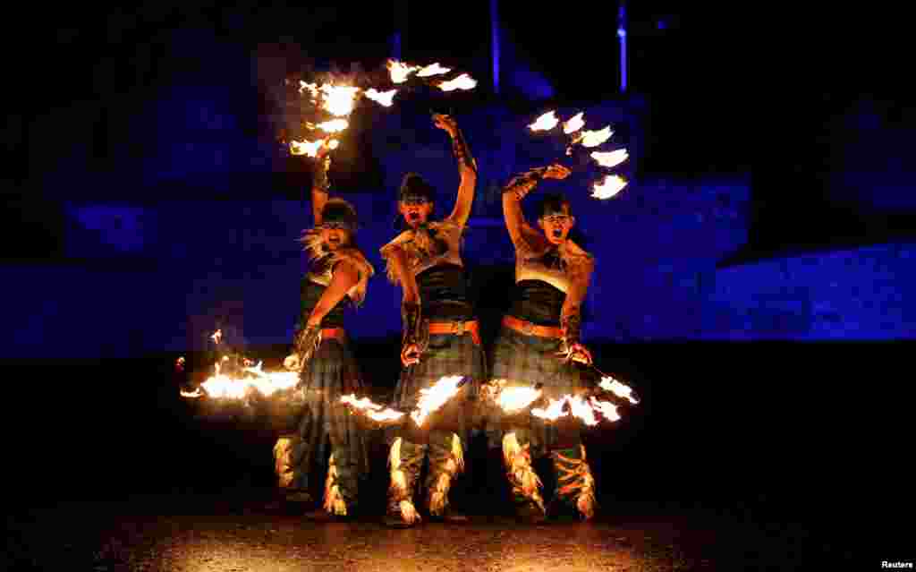 Members of PyroCeltica pose in front of Edinburgh Castle in advance of Edinburgh's Hogmanay torchlit procession down the Royal Mile in Edinburgh, Scotland, Britain, Dec. 30, 2018.