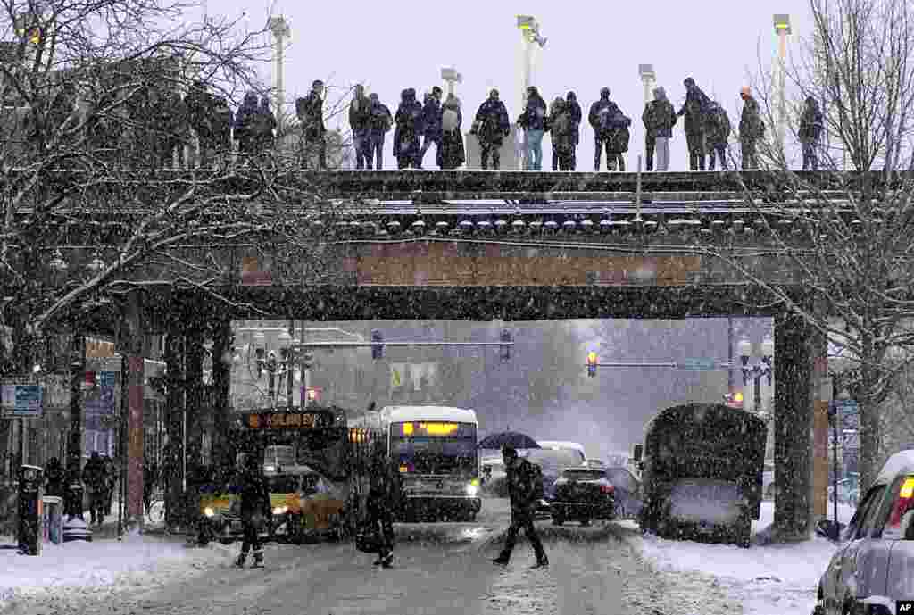 Commuters wait for a train as snow falls in Chicago, Illinois. The plunging temperatures expected later this week that have forecasters especially concerned. Wind chills could dip to negative 55 degrees in northern Illinois, which the National Weather Service calls "possibly life threatening."