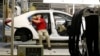 Technicians work on a Toyota Corolla assembly line, Blue Springs, Mississippi, Feb. 12, 2015.