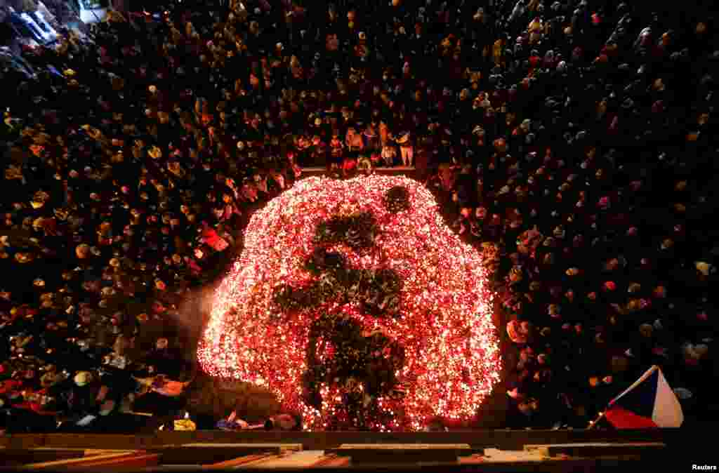People light candles at the Velvet Revolution memorial during the commemoration of the 32nd anniversary of the 1989 Velvet Revolution in Prague, Czech Republic.