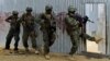 FILE - Somali soldiers search through homes for al-Shabaab fighters, during an operation in Ealsha Biyaha, Somalia, June, 2, 2012. On Tuesday, Somali forces attacked a base of the militant group north of Kismayo.