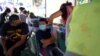 A health worker inoculates a boy with a dose of the Pfizer-BioNTech vaccine against COVID-19 at the Thai CDC’s vaccination mobile clinic at Wat Thai (Thai Temple) Los Angeles , Nort Hollywood, Los Angeles, CA. November 28, 2021.