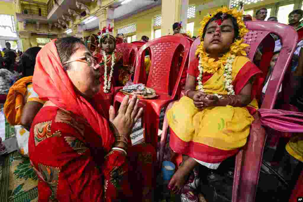 Young girls are dressed up as living goddesses and worshipped as 'kumari' or virgin during Bengali Hindu festival Basanti Durga Puja in Kolkata, India.