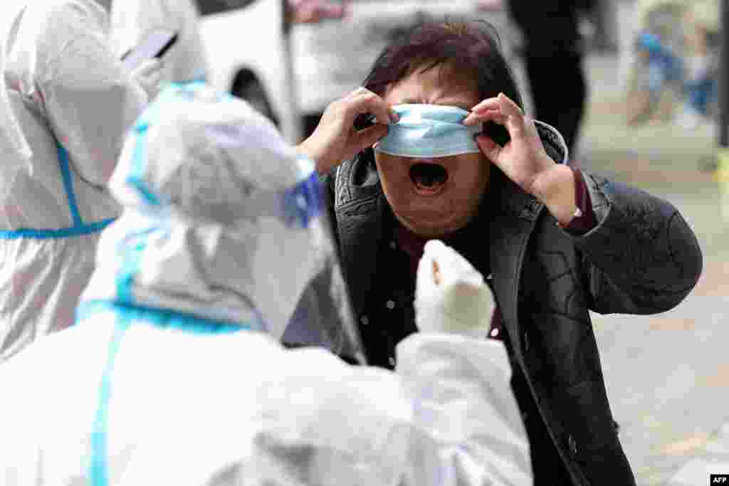 A resident undergoes a nucleic acid test for the COVID-19 in Shenyang, in China's northeastern Liaoning province.