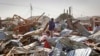 A shopkeeper surveys the wreckage of shops destroyed by a blast in a market in the capital Mogadishu, Somalia, Feb. 19, 2017. 