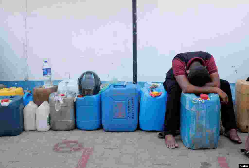 A man rests while waiting in a line to buy diesel near a Ceylon Petroleum Corporation fuel station, amid the country's economic crisis in Colombo, Sri Lanka.