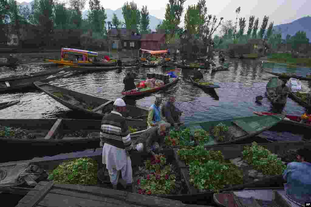 Kashmiri men sell their produce at the floating vegetable market on the Dal Lake in Srinagar, Indian controlled Kashmir.