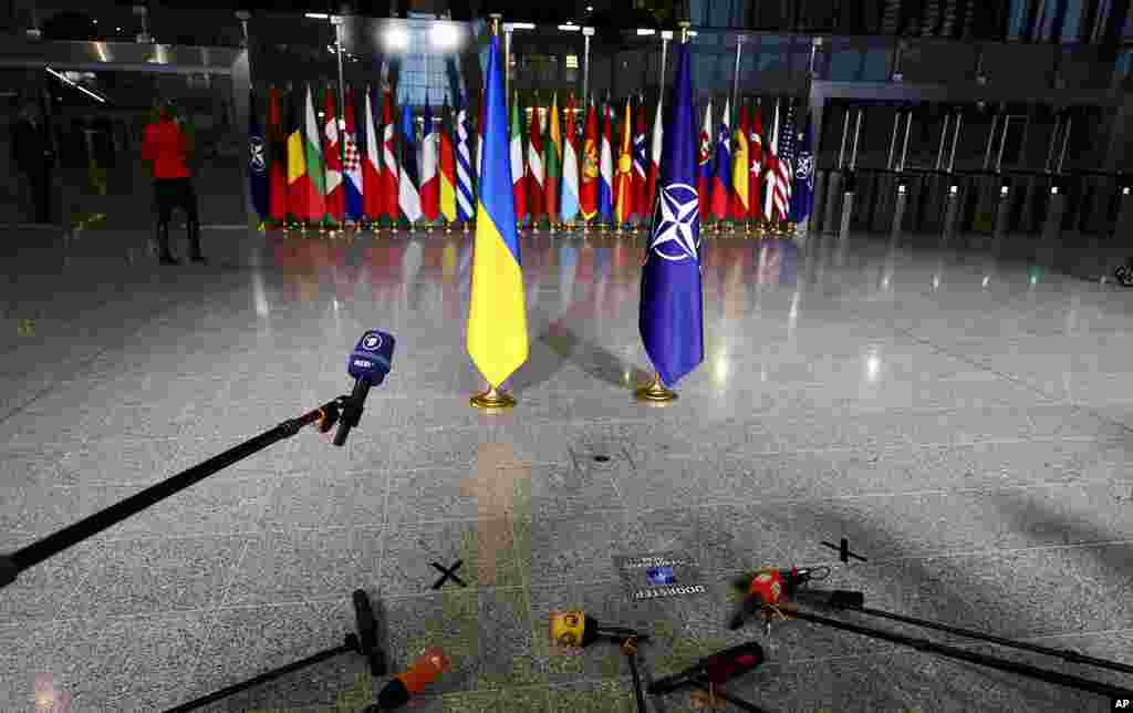 Members of the media prepare their microphones as they wait for the arrival of Ukraine's Foreign Minister Dmytro Kuleba and NATO Secretary General Jens Stoltenberg at a meeting of NATO foreign ministers at NATO headquarters in Brussels.