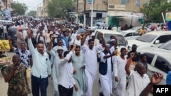 Pessoas celebram em Porto Sudão o avanço das forças militares sudanesas e dos grupos armados aliados sobre a capital do estado de Al-Jazira, Wad Madani, detida pelas Forças de Apoio Rápido (RSF) paramilitares, a 11 de janeiro de 2025.