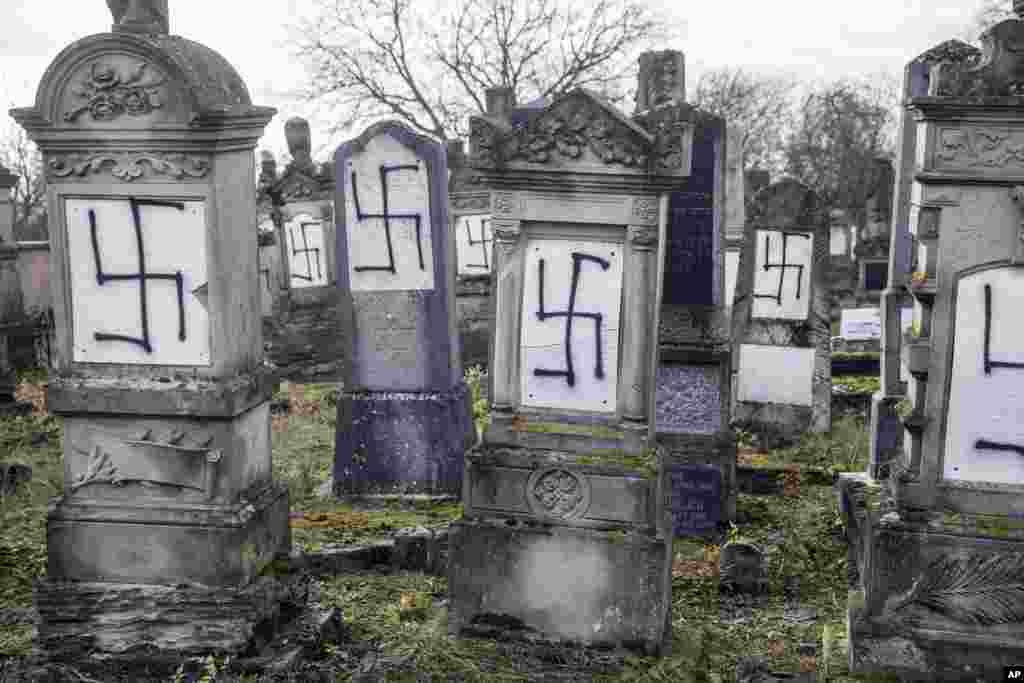 Jewish tombstones are seen desecrated with swastikas in the Herrlisheim Jewish cemetery, north of Strasbourg, eastern France.
