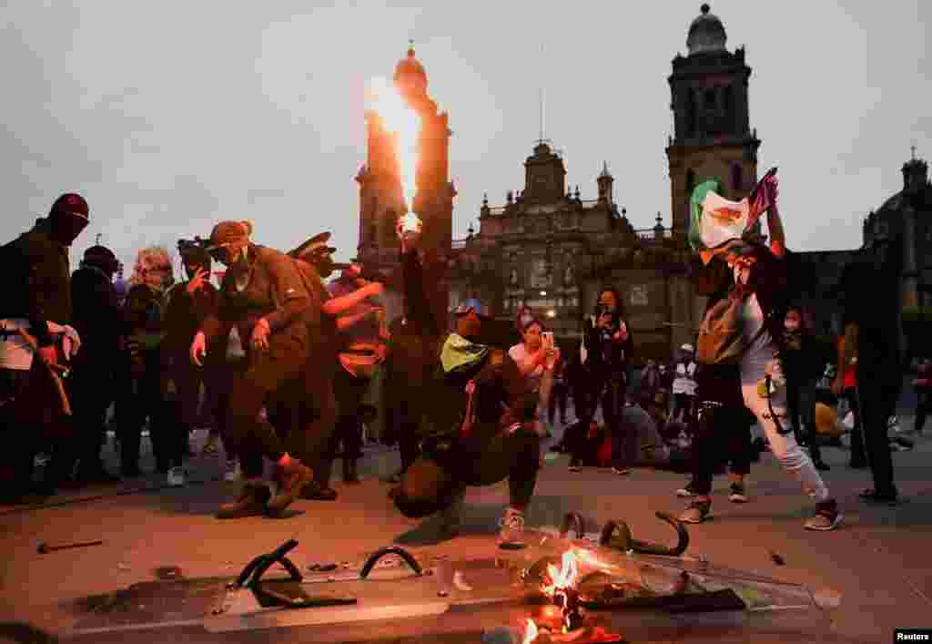 Demonstrators burn police shields during a protest to mark the International Day for the Elimination of Violence Against Women, in Mexico City.