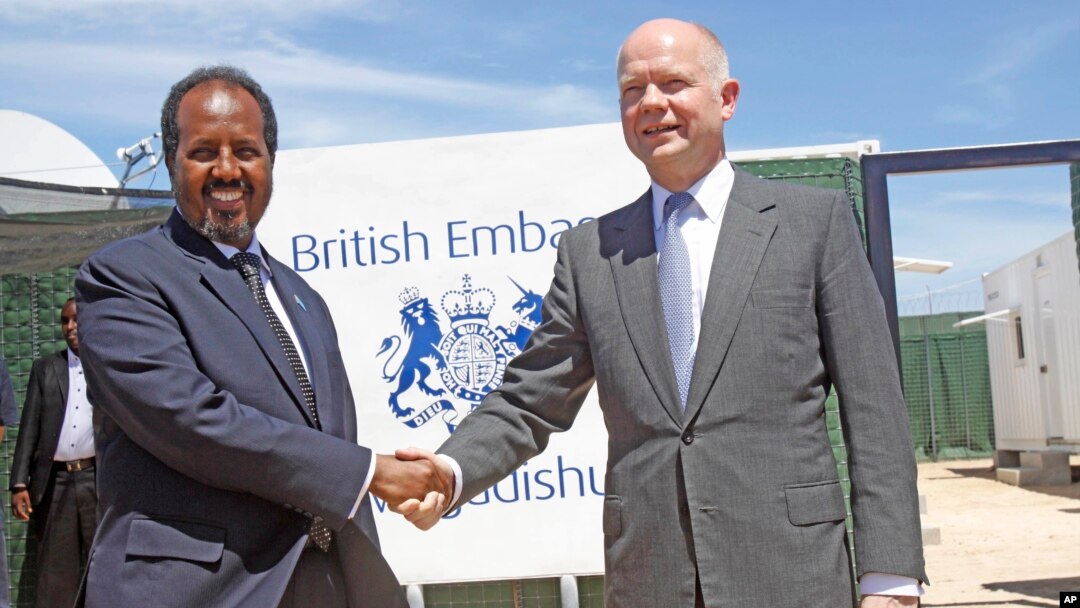 British Foreign Secretary William Hague, right, shakes hands with Somali President, Hassan Sheikh Mohamud, at the opening of the newly built British Embassy in the Somali capital Mogadishu, Apr. 25, 2013.