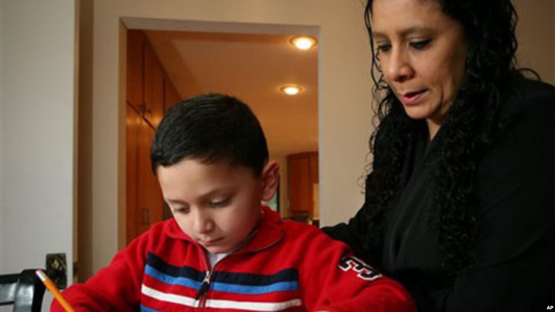 Ashton Faller doing homework with his mother last year. Ashton has received treatment for autism since he was two years old.