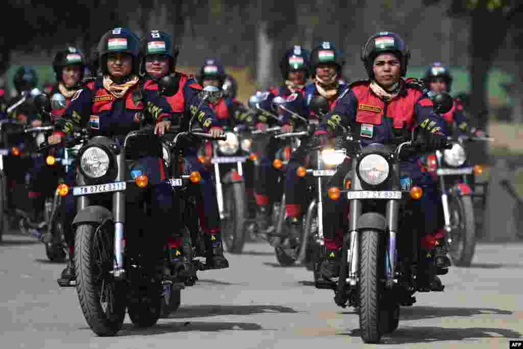 Indian Border Security Force personnel from the women's motorcycle team 'Sema Bhawani' ride their Royal Enfield motorcycles during the BSF Seema Bhawani Shaurya expedition-Empowerment Ride at India Gate in New Delhi, to mark International Women's Day.