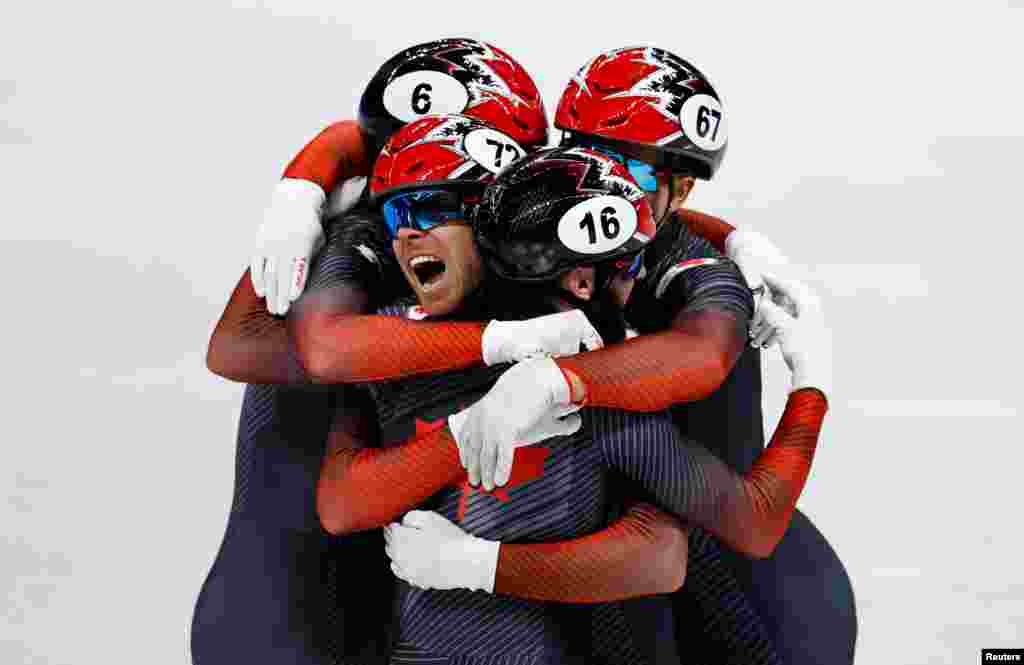 Canadian teammates Charles Hamelin, Pascal Dion, Steven Dubois and Jordan Pierre-Gilles celebrate after winning the final A of the men's 5000 meter relay short track speed skating during the 2022 Beijing Olympics at the Capital Indoor Stadium in Beijing.