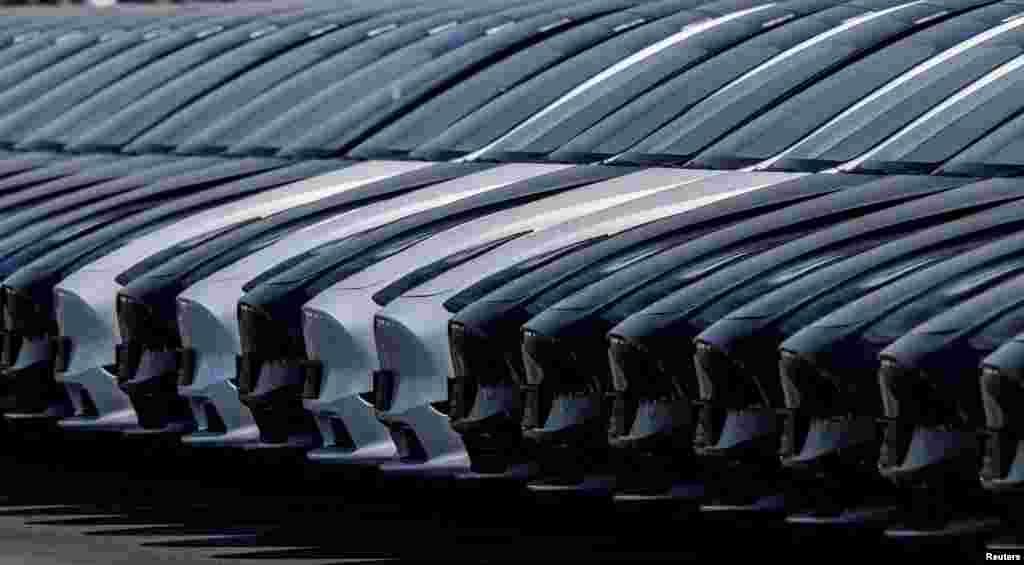 Tesla cars are seen parked at the construction site of the new Tesla Gigafactory for electric cars in Gruenheide, Germany.