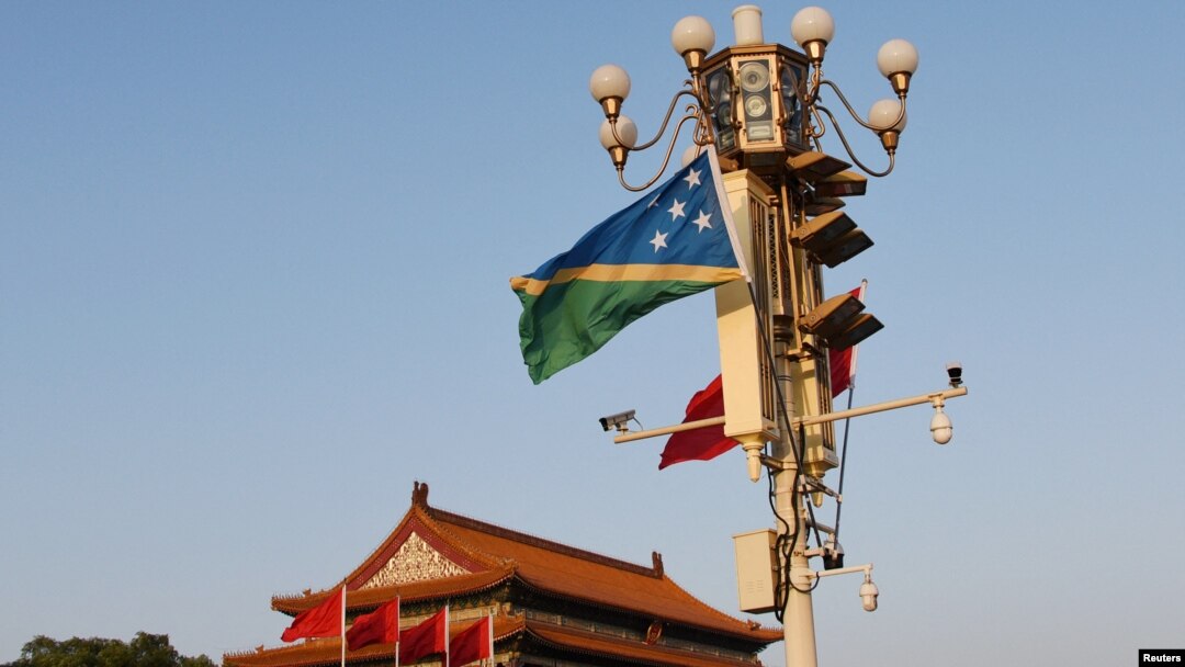 FILE - National flags of the Solomon Islands and China flutter at Tiananmen Square in Beijing, China, Oct. 7, 2019.