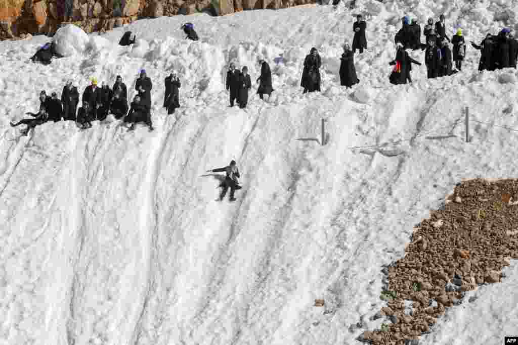 Ultra-Orthodox Jews play in the snow at the Hermon ski resort in the strategic Israeli-annexed Golan Heights.