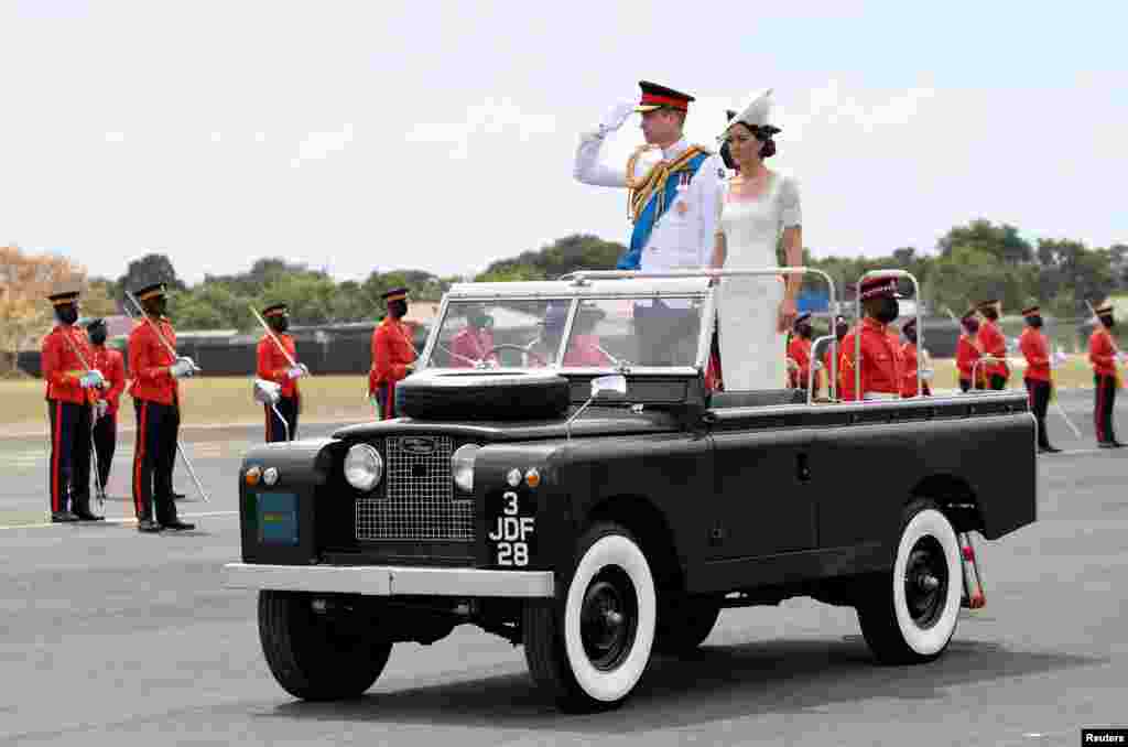 Britain's Prince William and Catherine, Duchess of Cambridge, ride in a vintage Land Rover used by Britain's Queen Elizabeth during her visit to Jamaica, as they leave the inaugural Commissioning Parade for service personnel completing the Caribbean Military Academy's Officer Training Program, in Kingston, Jamaica.