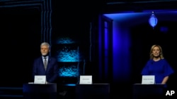 Presidential candidates Danuse Nerudova, left, and Petr Pavel wait for the start of a political debate at the National Museum in Prague, Czech Republic, Jan. 8, 2023. 