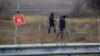 Ukrainian mine experts scan for unexploded ordnance and landmines by the main road to Kherson, Ukraine, Nov. 16, 2022.