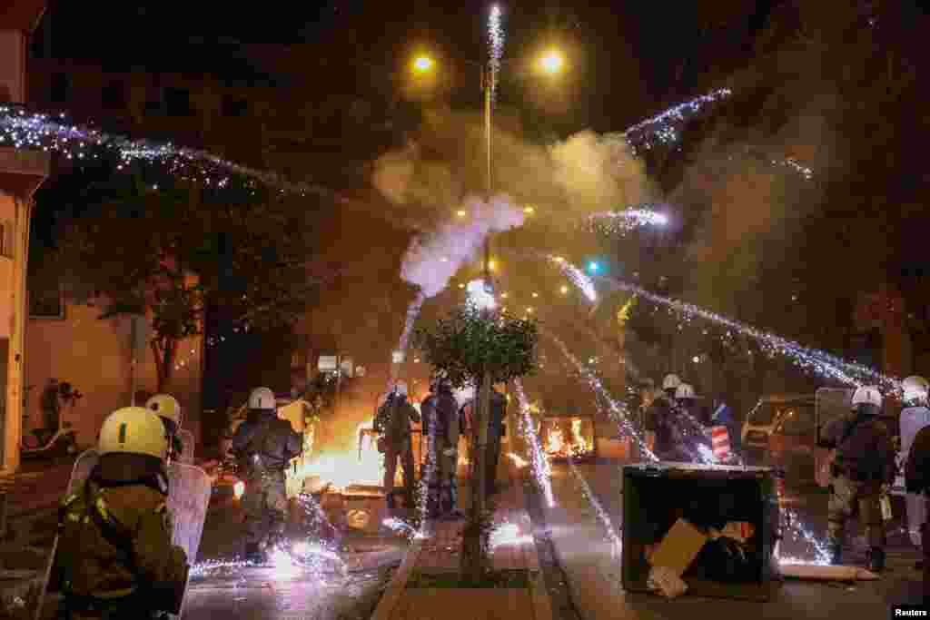 A firework explodes over riot police officers during clashes with demonstrators following an anniversary rally marking the 2008 police shooting of 15-year-old student Alexandros Grigoropoulos, in Thessaloniki, Greece, Dec. 6, 2022.