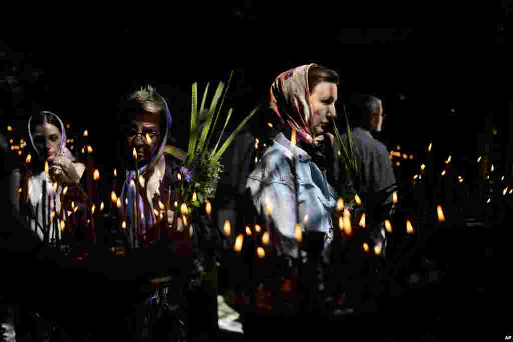 Women attend a Mass at St. Volodymyr's Cathedral during Orthodox Pentecost in Kyiv, Ukraine.