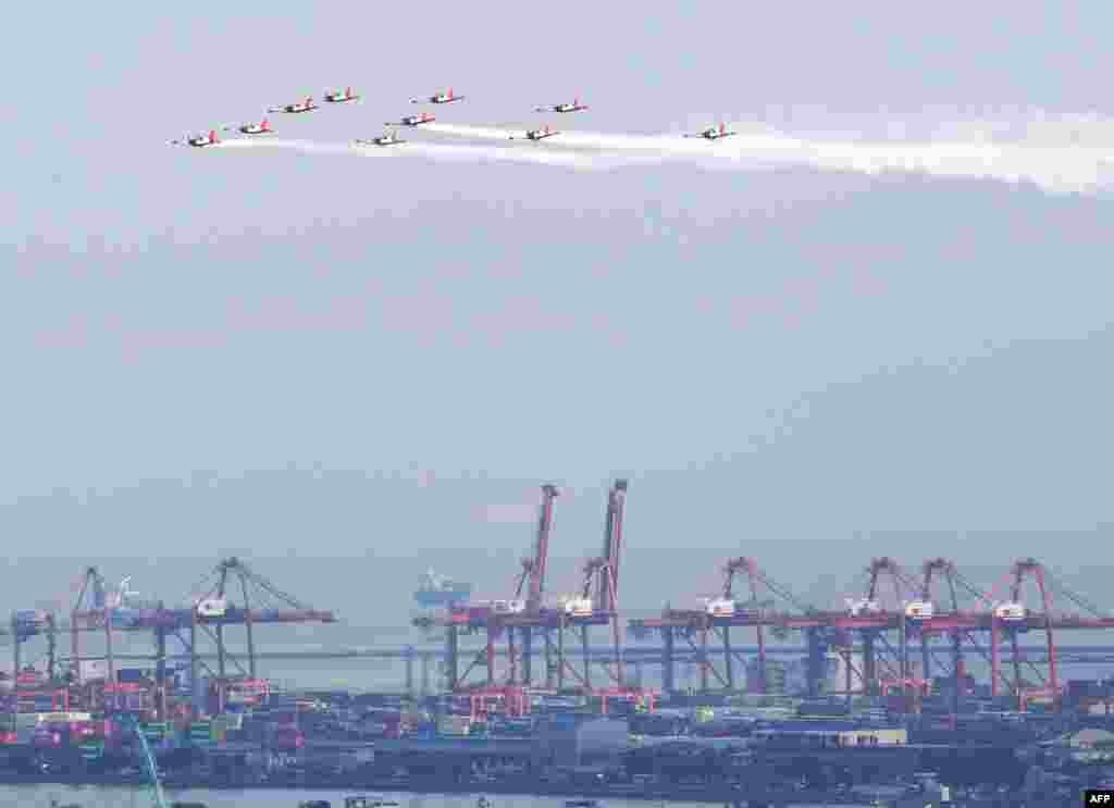 Philippine air force training aircrafts SF-260 fly in formation during a flyby practice near Rizal park in Manila, ahead of the Independence Day celebration on June 12.
