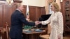 FILE - Russian President Vladimir Putin meets with Commissioner for Children's Rights Maria Lvova-Belova at the Kremlin in Moscow, March 9, 2022. The commissioner, who is being sought for war crimes for deporting children from Ukraine, said Wednesday they were taken for safety. 