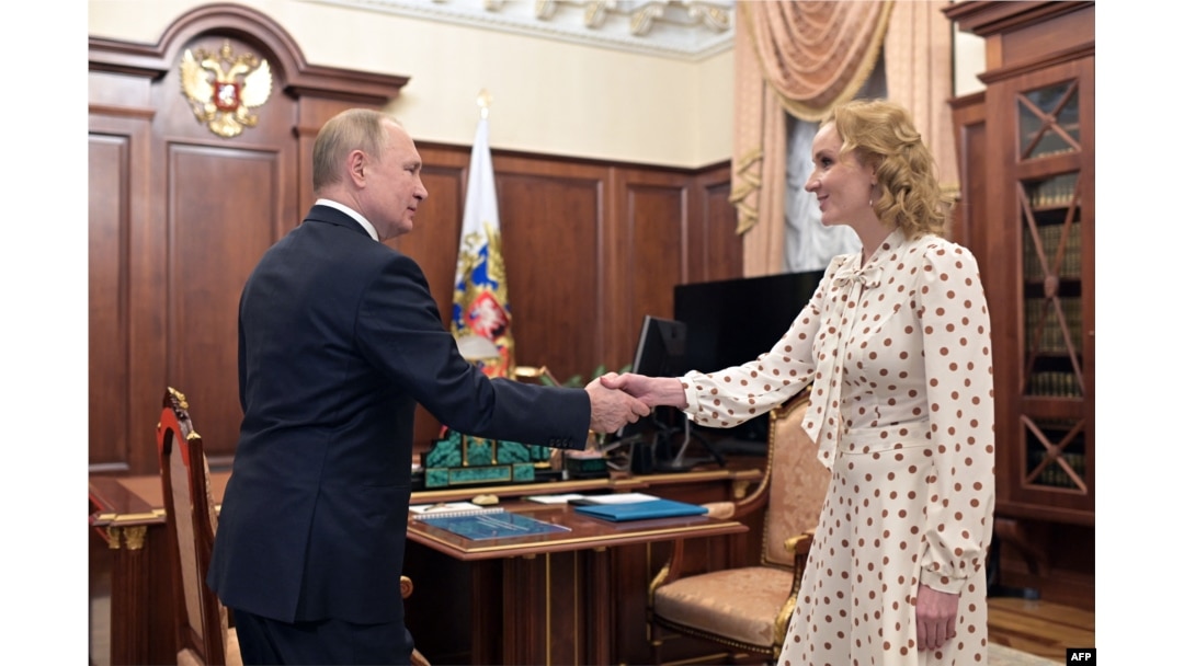 FILE - Russian President Vladimir Putin meets with Commissioner for Children's Rights Maria Lvova-Belova at the Kremlin in Moscow, March 9, 2022.