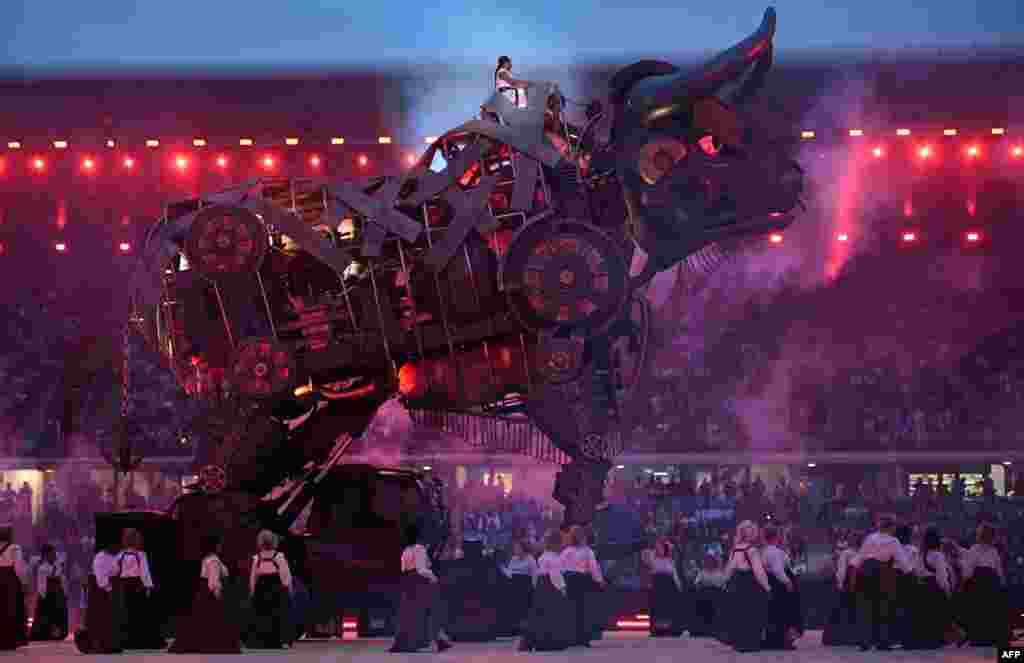 Stella, played by performer Lorell Boyce, left, sits atop the "Raging Bull" during the opening ceremony for the Commonwealth Games at the Alexander Stadium in Birmingham, central England, July 28, 2022.