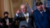 Senate Majority Leader Chuck Schumer, D-N.Y., joined at right by Sen. Chris Murphy, D-Conn., speaks with reporters following a closed-door policy lunch in Washington, June 14, 2022. 
