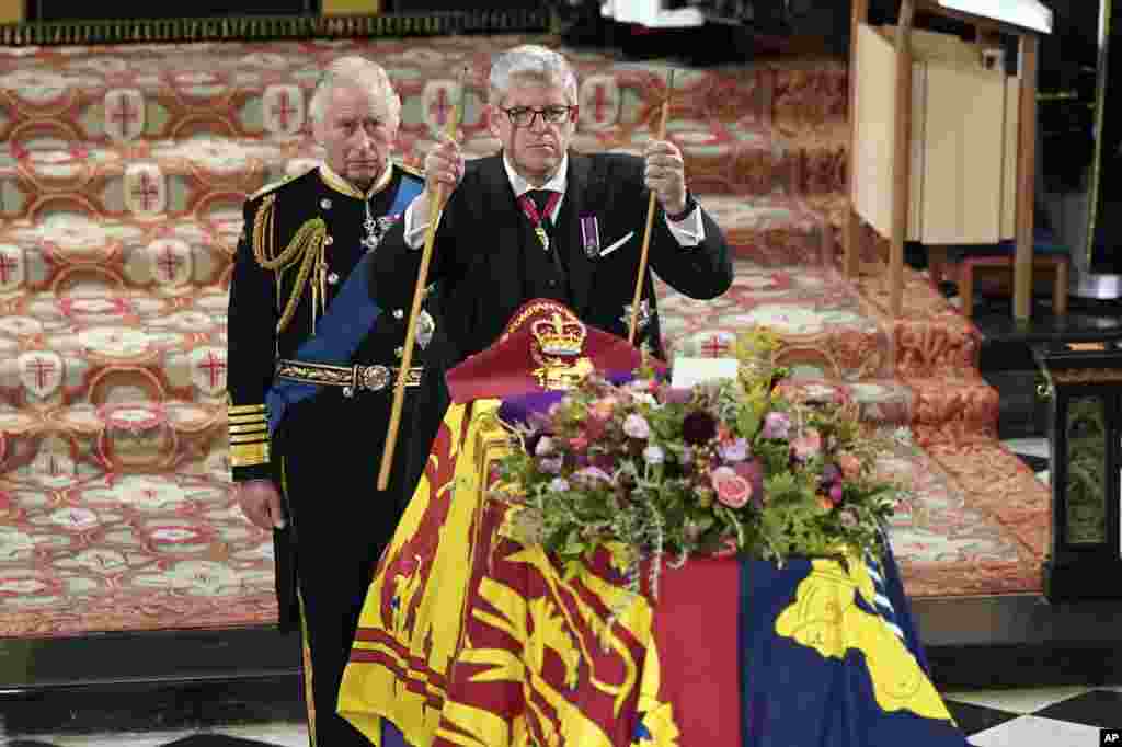 King Charles II, left, watches as The Lord Chamberlain Baron Parker breaks his Wand of Office, marking the end of his service to the sovereign, during the Committal Service for Queen Elizabeth at St. George's Chapel, Windsor Castle in Windsor, Sept. 19, 2022. Britain's longest-serving monarch and died in Scotland on Sept. 8. She was 96.