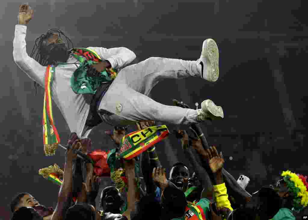 Senegal's players celebrate with head coach Aliou Cisse after winning the African Cup of Nations 2022 final soccer match between Senegal and Egypt at the Ahmadou Ahidjo stadium in Yaounde, Cameroon, Feb. 6, 2022.