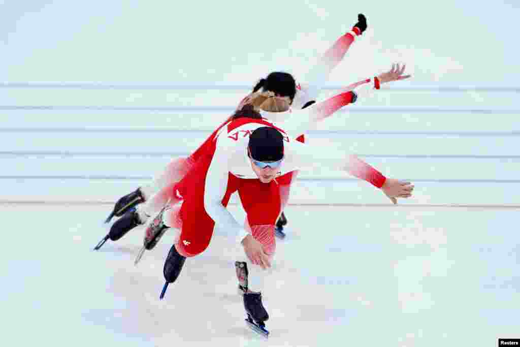 Athletes of Poland warm up before the men's 5,000-meter speedskating race at the 2022 Winter Olympics in Beijing.