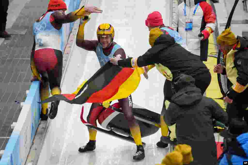 Johannes Ludwig of Germany celebrates winning the gold medal in luge men's singles at the 2022 Winter Olympics in the Yanqing district of Beijing.