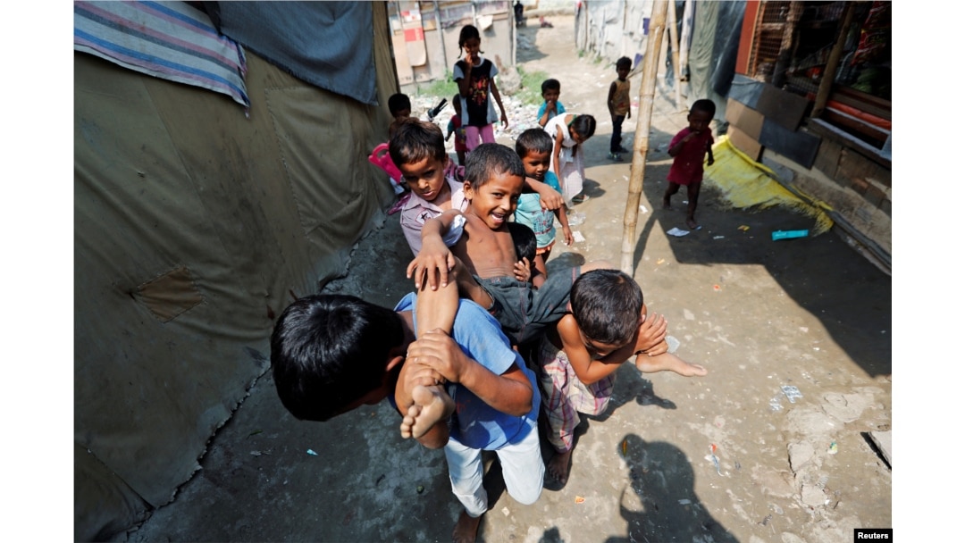 Children from the Rohingya community play outside their shacks in a camp in New Delhi, Oct. 4, 2018.