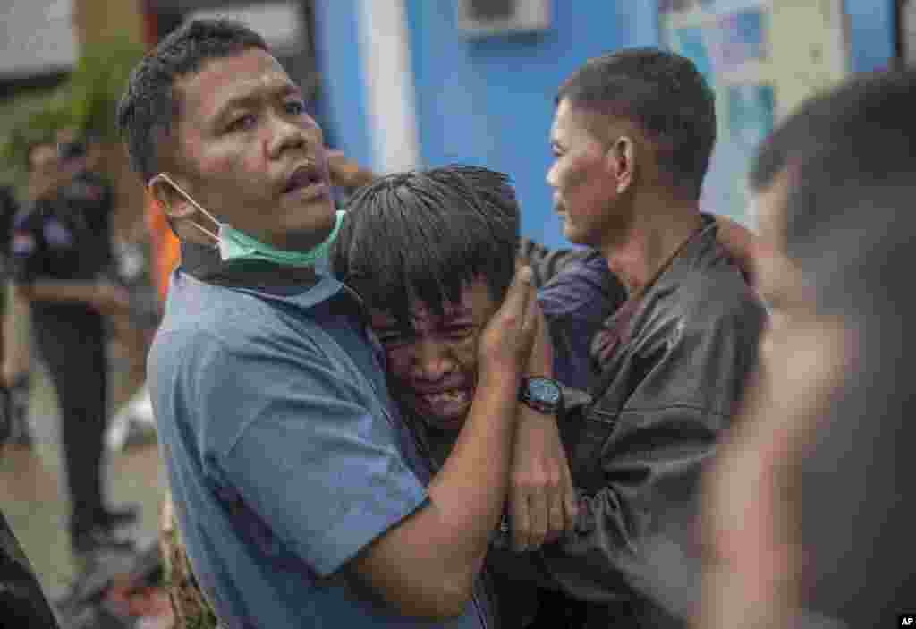 A man reacts after identifying his relative among the bodies of tsunami victims in Carita, Indonesia.