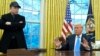 President Donald Trump speaks with reporters as Elon Musk listens in the Oval Office at the White House, Feb. 11, 2025, in Washington. 