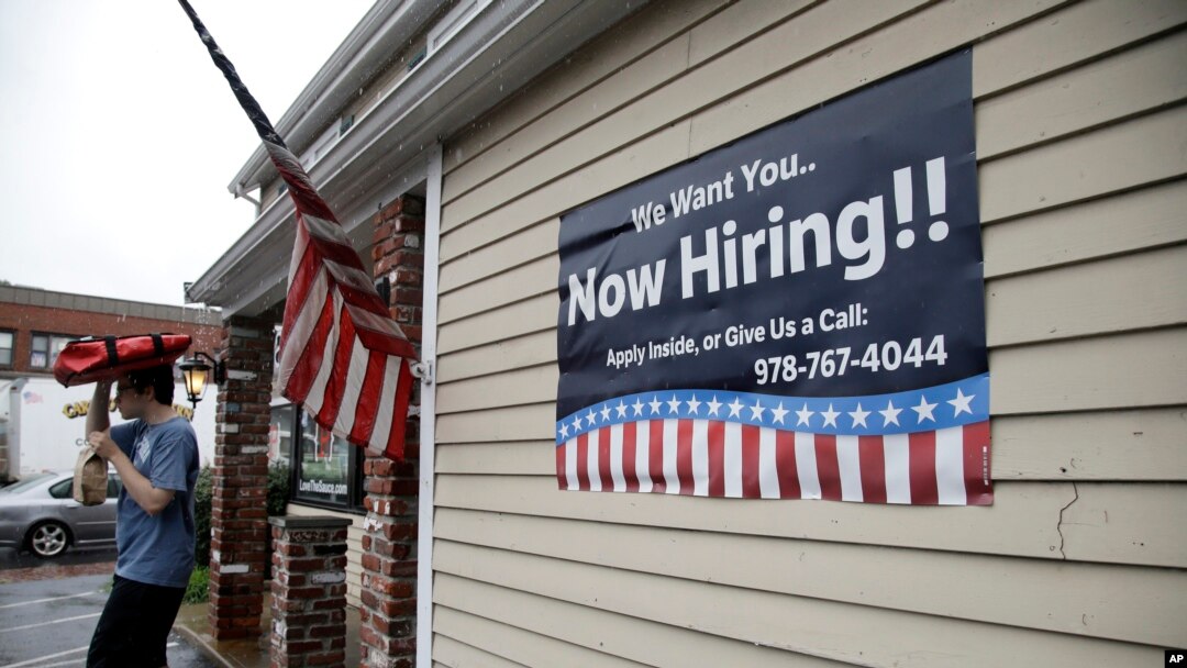 A sign advertising employment hangs outside a restaurant in Middleton, Massachusetts, July 24, 2017.