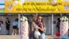 A couple takes a selfie in front of the Wat Thai of Los Angeles Food Court at Wat Thai (Thai Temple) of Los Angeles, North Hollywood, CA. November 06, 2021.