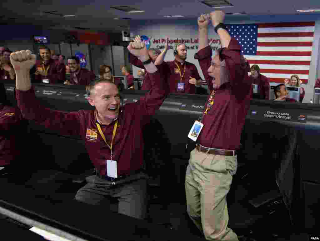 Mars InSight team members Kris Bruvold, left, and Sandy Krasner react after receiving confirmation that the Mars InSight lander successfully touched down on the surface of Mars, Nov. 26, 2018 inside the Mission Support Area at NASA's Jet Propulsion Laboratory in Pasadena, California. InSight, short for Interior Exploration using Seismic Investigations, Geodesy and Heat Transport, is a Mars lander designed to study the "inner space" of Mars: its crust, mantle, and core.
