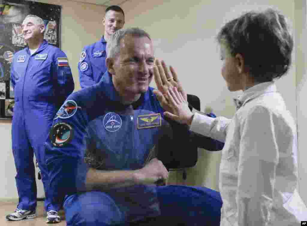 Canadian astronaut David Saint Jacques interacts with his son during a news conference in Russian-leased Baikonur cosmodrome, Kazakhstan. The new Soyuz mission to the International Space Station (ISS) is scheduled on Dec. 3, with U.S. astronaut Anne McClain, Russian cosmonaut Оleg Kononenko‎ and CSA astronaut David Saint Jacques.