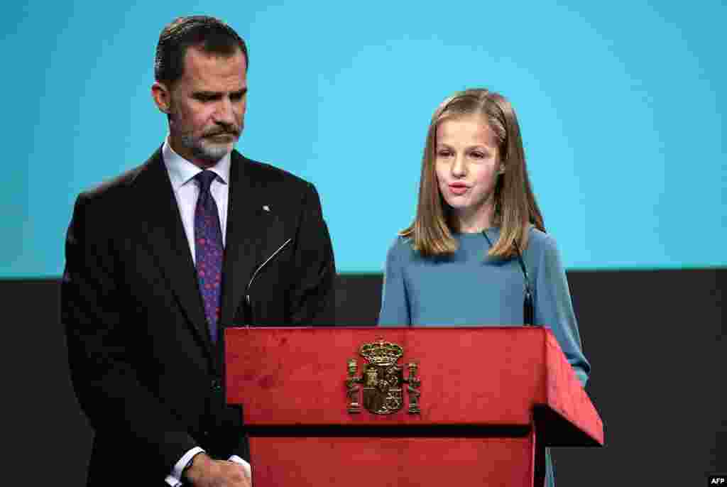 Spanish heiress of the throne, princess Leonor (R), reads the Spanish Constitution under the eyes of her father king Felipe VI, during a ceremony marking 40 years of its approval by the parliament, at the Cervantes Institute in Madrid.
