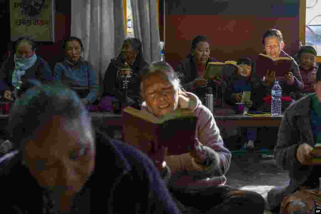 Tibetans gather to offer prayers in remembrance of those who lost their lives in the recent earthquake, at a Tibetan camp in Lalitpur, Nepal.